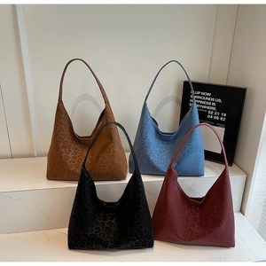 Group shot of large leopard print tote bags in brown, blue, black, and burgundy velvet