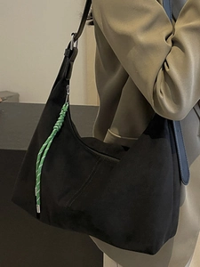 Minimalist black suede hobo tote bag for women featuring a stylish green braided rope detail