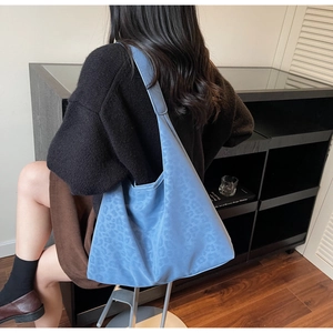 Detail view of blue leopard pattern tote bag in soft suede fabric for daily commute wear