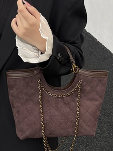 Quilted dark brown suede tote bag with elegant gold chain straps for a stylish look