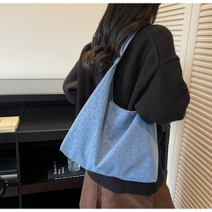 Detail of light blue leopard jacquard tote bag showing fabric texture and capacity