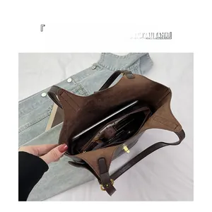 Detail view of large capacity brown tote bag interior with multiple compartments