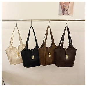 Macro detail of tote bags showing premium faux leather texture and gold buckle accents