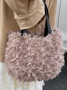 Chic mauve faux fur bucket handbag with black handles and fluffy curly texture