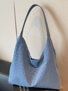 Blue leopard pattern tote bag with satin jacquard finish and hobo style shoulder strap