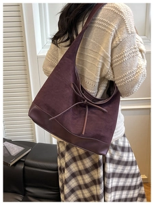 Detail view of purple suede Hobo bag with bow tie showing texture and stitch quality