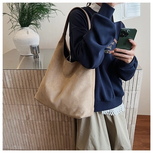 Detailed view of camel faux suede hobo tote bag with a minimalist large capacity design