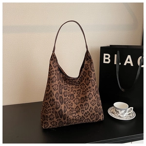 Detail of large leopard print hobo tote bag with slim brown handles for daily commute