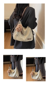 Detail of beige faux leather tote bag with vintage texture and cute plush bear charm