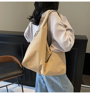 Détail du sac hobo kaki à grande capacité montrant la texture en nylon et la fermeture éclair