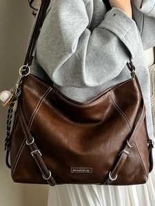 Vintage dark brown large capacity tote bag with leather texture and baseball pendant