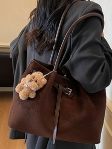 Vintage brown large suede tote bag with bear charm shown on model shoulder for daily commute