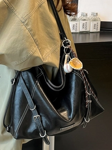 Vintage black faux leather tote backpack with contrast stitching and baseball charm detail