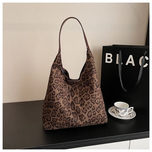 Detail of large dark brown leopard print hobo bag with sleek leather shoulder strap