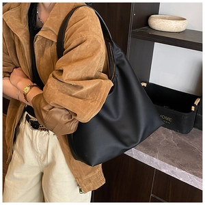 Classic black matte leather Hobo bag shown on model for daily commuting style