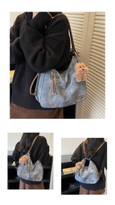 Detail view of vintage washed hobo bag with leather straps and plush bear keychain accessory
