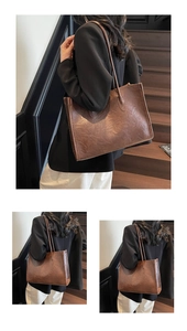 Detail view of large brown vintage tote bag in oil wax leather texture on stairs