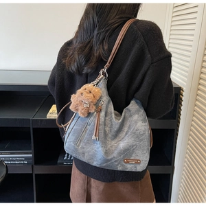 Washed gray canvas tote bag with brown leather straps and cute plush bear charm detail