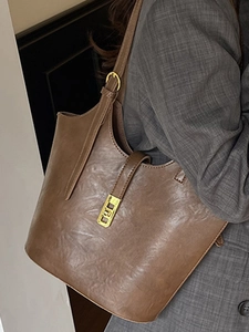 Minimalist vintage brown leather tote bag with gold buckle hardware for daily commuting