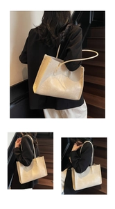 Detailed view of a cream minimalist leather tote bag with long dual shoulder straps