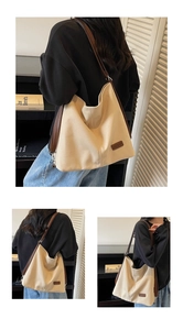 Detail of off-white canvas tote with brown leather strap and side logo patch