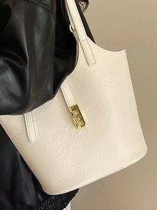 Minimalist cream white oversized tote bag with gold buckle for stylish daily commuting