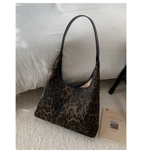 Detailed view of the leopard print hobo bag with textured fabric and wide shoulder strap