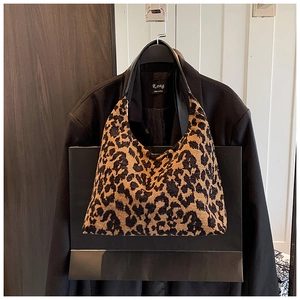 Detailed view of the leopard print faux fur tote bag with black leather handle