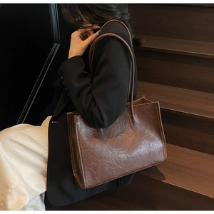 Close-up of vintage brown leather tote bag showing textured oil wax finish and large capacity