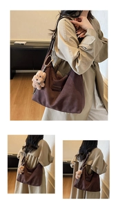 Detail of dark brown suede hobo tote bag featuring a leather logo tag and plush bear charm