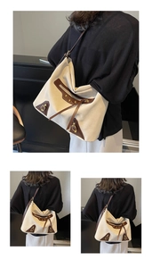Detailed macro view of retro canvas tote bag with brown leather trim and metal buckles