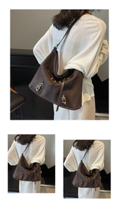 Detail view of large dark brown leather tote bag with vintage bronze buckle and zippers