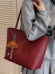 Schicke weinrote Leder-Tote-Bag mit Längsnähten und süßem Plüsch-Hundeanhänger