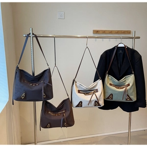 Macro detail of large retro tote bags in four colors with studs and long tassels