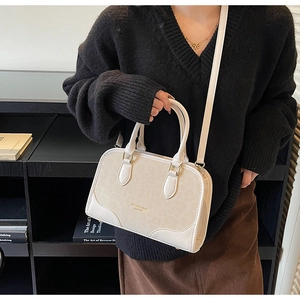 Detail of a chic cream leather tote bag featuring leopard print panels and golden hardware