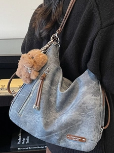 Gray-blue soft leather tote bag with vintage texture and puppy charm on shoulder