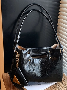 Retro black glossy pleated handbag with cutout handle and matching small coin purse charm