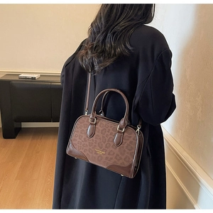 Detail of leopard print Boston bag featuring faux leather trim and sturdy dual handles