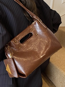 Vintage dark brown oil wax leather handbag with rivet detail and small coin purse charm