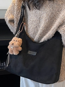 Large black hobo tote bag with a cute brown puppy charm for casual winter commuting