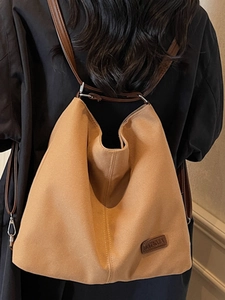 Versatile large tote bag in camel suede with adjustable leather straps for shoulder or backpack use