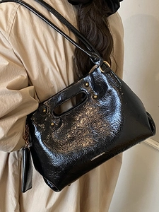 Retro black glossy leather handbag with shoulder straps and vintage rivets for women