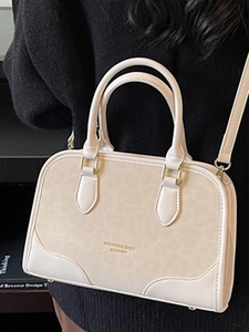 Fashionable leopard print pillow handbag with top handles and shoulder strap in off-white