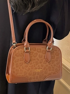 Fashionable leopard print Boston bag in brown leather with top handles and shoulder strap