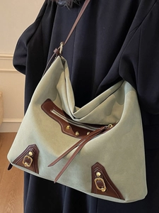 Vintage green suede tote bag with brown leather trim and rivets for daily office commute