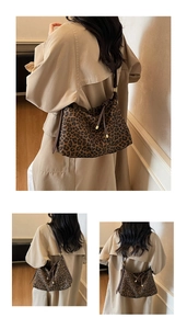 Detail view of leopard print crossbody bag with drawstring design and gold metal accents