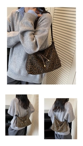 Close-up detail of leopard print hobo bag with leather drawstring and gold metal accents