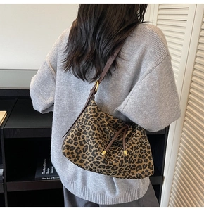 Detail view of large leopard print tote bag with adjustable brown drawstring strap