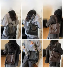 Detailed close-up showing woven leather texture and metal handle of large bucket bag
