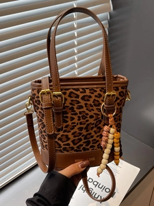 Vintage leopard print bucket bag with brown leather trim and stylish beaded charm